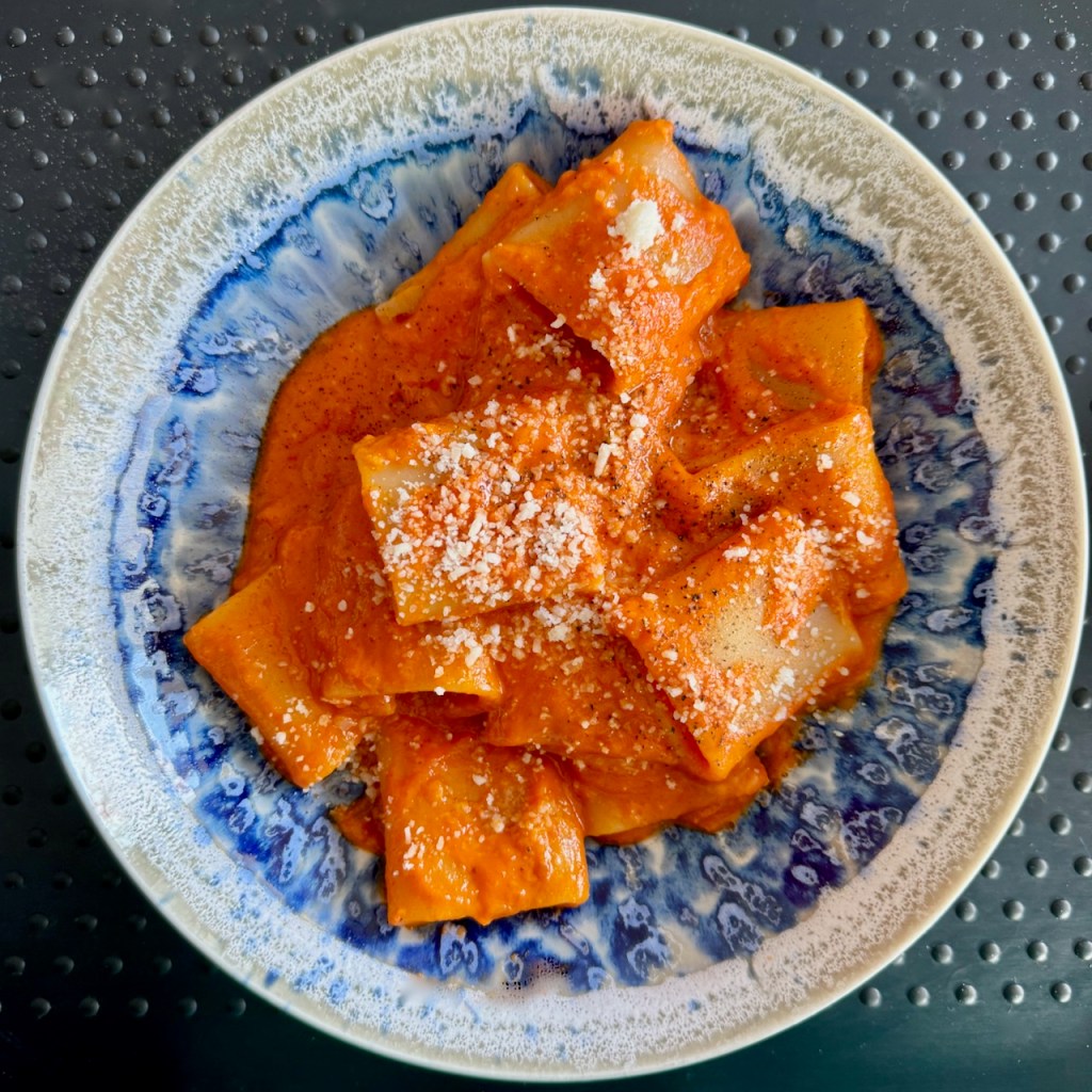 Pasta with a creamy tomato sauce and sprinkled with grated parmesan cheese.